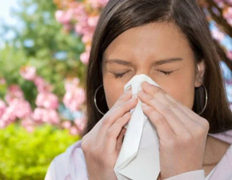 "Image: A woman holding her nose, indicating a need for mold testing in her home. Her gesture suggests concern about potential mold issues, highlighting the importance of proactive testing for a healthy living environment."