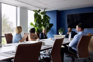"Image: A group of professionals gathered in a conference room within a mold-free office building. The atmosphere is conducive to productive discussions and presentations, emphasizing cleanliness and healthiness."